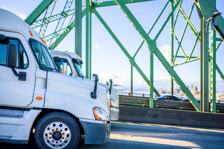 Two different industrial big rigs diesel bonnet semi trucks for long haul and local deliveries...
