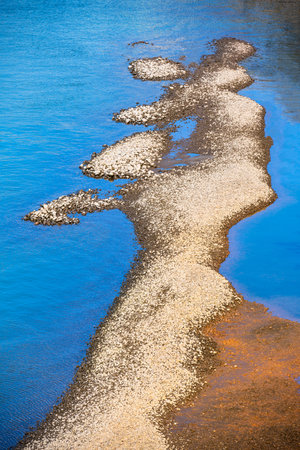 The riverbank which has become shallow laid bare the bottom forming an islet of land of bizarre...