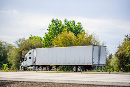 Big rig white long haul industrial semi truck tractor with sleeper cab compartment for truck driver...