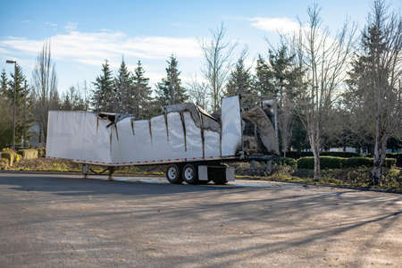 Completely Burned damaged dry van semi trailer without big rig semi truck tractor standing on the industrial parking lot waiting for possible repair or recyclingの写真素材