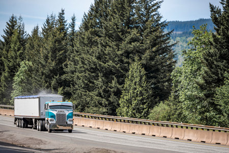 Old style cab over big rig industrial semi truck tractor transporting dusty cargo in covered low...