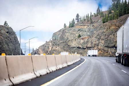 Team of group big rigs industrial professional semi trucks tractors transporting cargo in different...