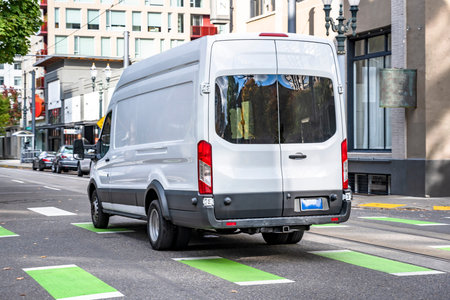 Compact small size white mini van with cargo compartment for local deliveries and small business...