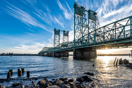 Arched sectional truss lift Columbia River Interstate drawbridge over the Columbia River through which Interstate I-5 passes along the entire western coast of America connects at twilightの写真素材