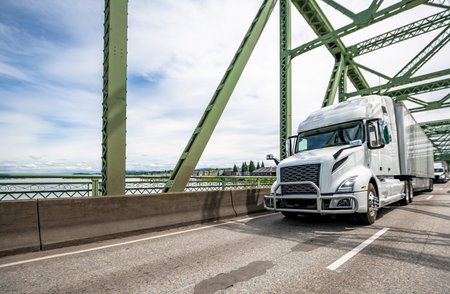 White bonnet industrial grade big rig semi truck with truck driver cab sleep compartment and with...