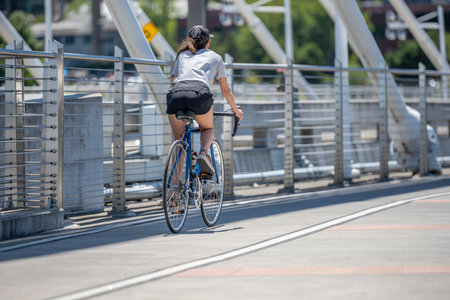 A woman on bicycle and cycling rides are great tools for improving health of the muscles of the hip belt reducing weight and improving female libido improving psychological stability in lifestyleの写真素材