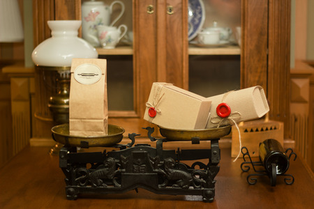 Retro craft cardboard packages with red seals on old scales Vintage shop interior.の写真素材