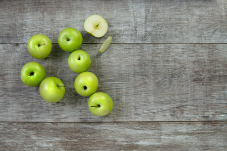 green apples on a wooden table topの写真素材
