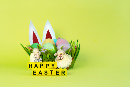 pastel colored eggs in nest easr bunny and the inscription of the cubes happy Easter