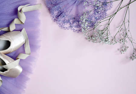 ballerina shoes pointe shoes with a tutu skirt of different colors on a pink background with flowersの写真素材