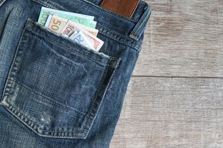 euro, bills in the pocket of jeans. The concept of pocket money. Cash. European money. business, trade or financial transactions, seasonal discounts. close-upの写真素材