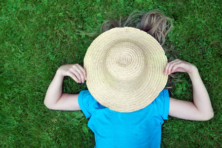 girl smiles on a hammock in summer. the concept of the summer of childhood happiness