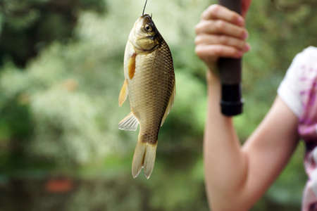 girl fishing holding a fishing rodの写真素材