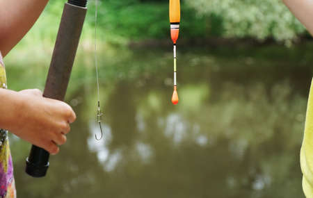 girl fishing holding a fishing rodの写真素材