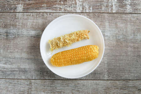 before and after corn on a plate whole and eatenの写真素材