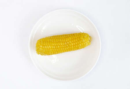 Ripe corn . the cob is yellow. Isolate on a white plateの写真素材