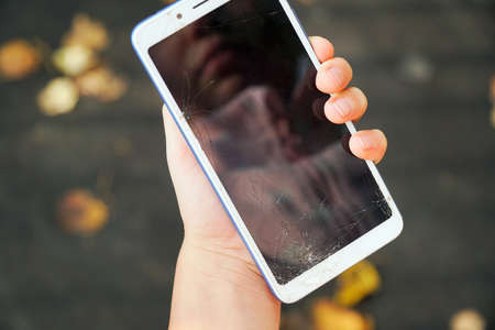 brokenmobile phone screen in the rivers of the childの写真素材