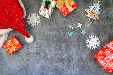Santa Claus hat, gifts, Christmas tree, snowflakes on a blue backgroundの写真素材