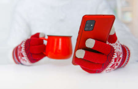 Red gloves, red mug and red phoneの写真素材