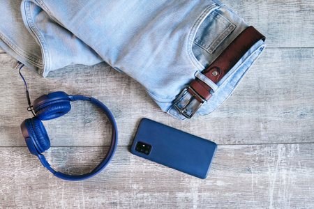 Blue jeans, blue smartphone and headphones