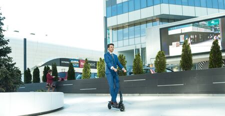 BUCHAREST, ROMANIA, - Octomber 26, 2017: Using Electric Scooter on the street on a sunny day with sarf effect and blurry. Editorial content.のeditorial素材
