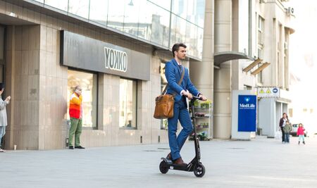 BUCHAREST, ROMANIA, - Octomber 26, 2017: Using Electric Scooter on the street on a sunny day with sarf effect and blurry. Editorial content.のeditorial素材