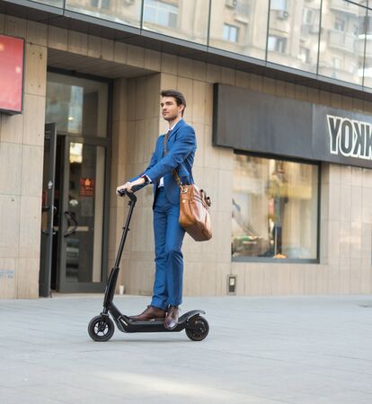 BUCHAREST, ROMANIA, - Octomber 26, 2017: Using Electric Scooter on the street on a sunny day with sarf effect and blurry. Editorial content.のeditorial素材