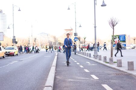 BUCHAREST, ROMANIA, - Octomber 26, 2017: Using Electric Scooter on the street on a sunny day with sarf effect and blurry. Editorial content.のeditorial素材