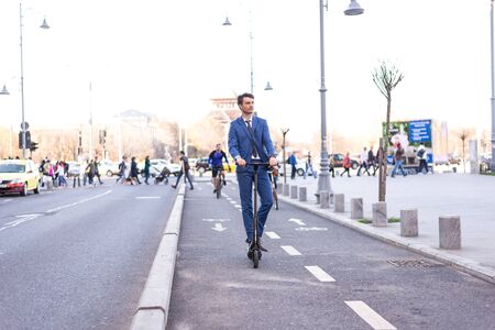 BUCHAREST, ROMANIA, - Octomber 26, 2017: Using Electric Scooter on the street on a sunny day with sarf effect and blurry. Editorial content.のeditorial素材
