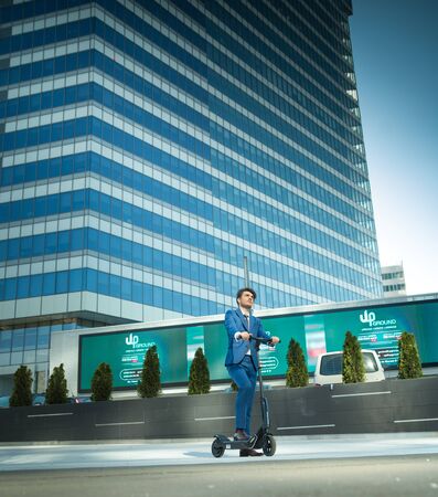 BUCHAREST, ROMANIA, - Octomber 26, 2017: Using Electric Scooter on the street on a sunny day with sarf effect and blurry. Editorial content.のeditorial素材