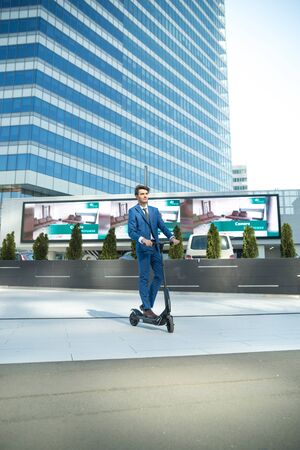 BUCHAREST, ROMANIA, - Octomber 26, 2017: Using Electric Scooter on the street on a sunny day with sarf effect and blurry. Editorial content.のeditorial素材