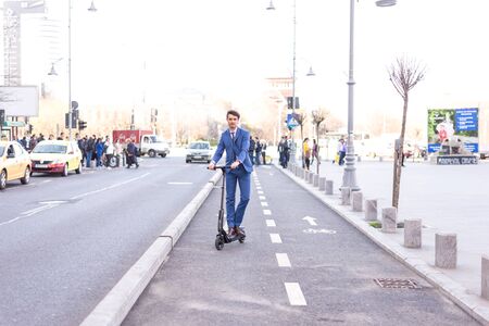 BUCHAREST, ROMANIA, - Octomber 26, 2017: Using Electric Scooter on the street on a sunny day with sarf effect and blurry. Editorial content.のeditorial素材