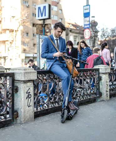 BUCHAREST, ROMANIA, - Octomber 26, 2017: Using Electric Scooter on the street on a sunny day with sarf effect and blurry. Editorial content.のeditorial素材