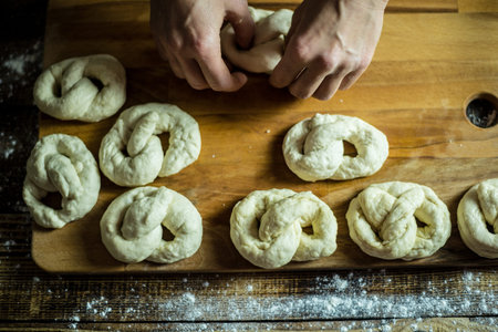 Dough dainted by the woman on the board