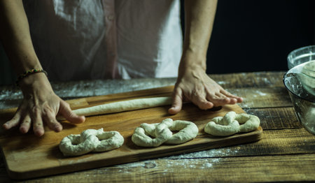 Dough dainted by the woman on the board