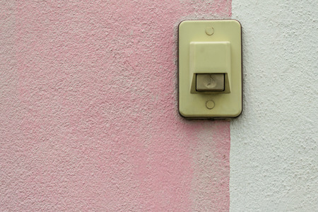 Electric switch Buzzer on pinkwhite wallの写真素材