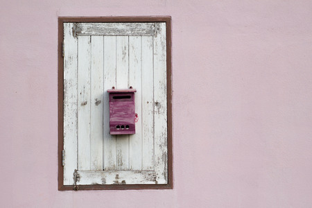 postbox on wood window with pink wall.の写真素材