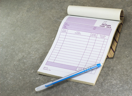 cash sale bill and pen on loft style table.の写真素材