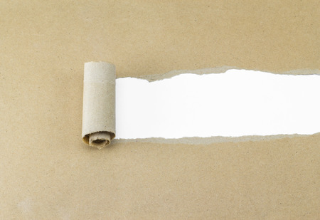 Torn brown paper on white surface for fill text.の写真素材