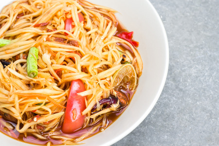 papaya salad (Som-tam) in dish on tableの写真素材