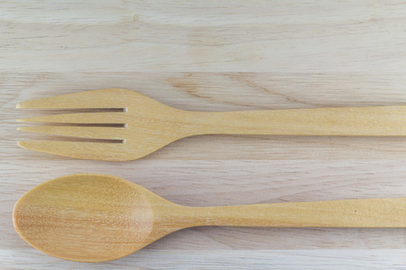 Wooden spoon and fork on table in top viewの写真素材