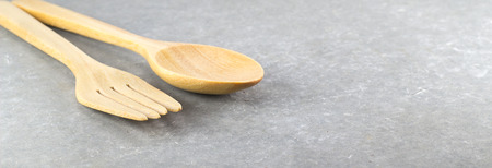 wood spoon and fork  on cement tableの写真素材