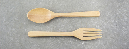 wood spoon and fork  on cement tableの写真素材