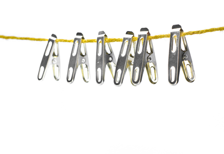 clothespin of stainless on rope with isolate whiteの写真素材