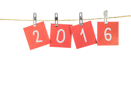 new year 2016 word hanging on the Notes paper cards in clothes pegs on rope with isolateの写真素材