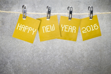new year 2016 word hanging on the Notes paper cards in clothes pegs on ropeの写真素材