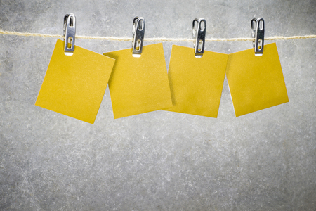 Notes paper cards in clothes pegs on ropeの写真素材