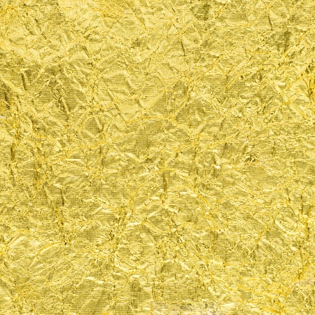 texture of golden sheet rumpled for backgroundの写真素材