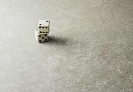 Old dice stacked on the concrete floorの写真素材