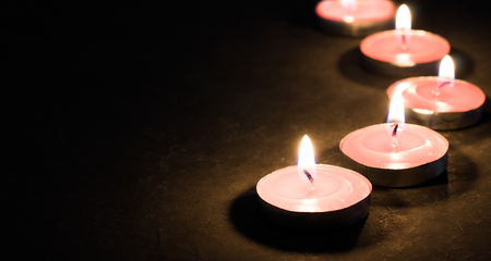 pink candle light on concrete plateの写真素材